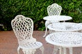 white chairs and table in lawn of garden Royalty Free Stock Photo