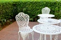 white chairs and table in lawn of garden Royalty Free Stock Photo