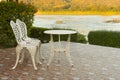 White chairs and table at the terrace with lake view Royalty Free Stock Photo