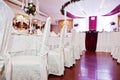 White chairs and tables of wedding quests.