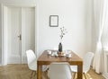 White chairs at wooden table in minimal dining room interior wit Royalty Free Stock Photo