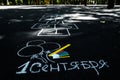 White chalk on black asphalt inscription in Russian September 1. yellow line, colorful markers, painted balls,hopscotch Royalty Free Stock Photo