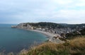 White chalk cliffs, beach and the town of Etretat in France