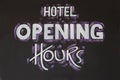 White chalk sign writing reading "Hotel Opening Hours" Royalty Free Stock Photo