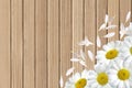 White chamomile flowers on wooden table background