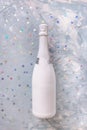 White champagne party bottle and stars confetti