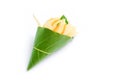 White Champaka Flowers in conical green leaf on white background