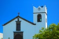 White chapel with bell tower against a blue sky