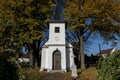 White chapel between the colored leaves