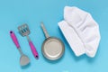 White chef hat on the blue background with kiddish toy utensils.