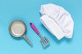 White chef hat on the blue background with kiddish toy utensils.