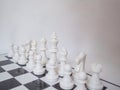 A white chess-Army is standing on a board with white background, challenges planning business strategy to success concept