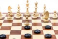 white chess and black checkers gaming on board Royalty Free Stock Photo
