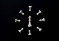 White chess clock on black background flat lay photo. White chess figures abstract ornament. Royalty Free Stock Photo