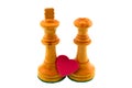 White chess figures, king and queen, showing a red heart Royalty Free Stock Photo