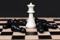 White Chess King with Fallen Black Chess Pawn