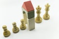 white chess pawns enter the door and exit as queens and kings Royalty Free Stock Photo