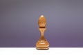 White Chess piece Bishop, officer or elephant. Old wooden Chessman for play the game of chess. Bishop on edge of table. Concept - Royalty Free Stock Photo