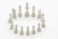 White chess pieces arranged in precise circular ring top down on white background isolated strategic planning and game concept Royalty Free Stock Photo