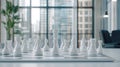 White chess pieces are meticulously positioned on a chessboard in a contemporary office environment, creating a focused Royalty Free Stock Photo