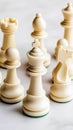 White chess pieces are meticulously positioned on a chessboard in a contemporary office environment, creating a focused Royalty Free Stock Photo