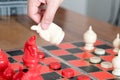 The white chess on women hand is fighting with red, think, discuss, committed, competition, winner, successful, dedicate concept