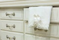 White chest of drawers with a towel