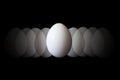 White chicken egg in the center and eggs pattern. Royalty Free Stock Photo