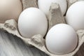 White chicken egg in a package close-up. Source of calcium, protein, lecithin, choline, vitamin, potassium, magnesium