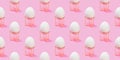 White chicken egg on sponge stand, pink background. Seamless creative pattern. Easter template