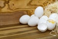 White chicken eggs and broken eggs on wooden board or table. Royalty Free Stock Photo
