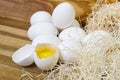 White chicken eggs and broken eggs on wooden board or table. Royalty Free Stock Photo