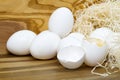 White chicken eggs and broken eggs on wooden board or table. Royalty Free Stock Photo