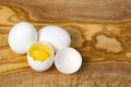 White chicken eggs and broken eggs on wooden board or table. close up Royalty Free Stock Photo