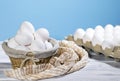 White Chicken eggs in a cardboard box and in a Straw basket on a light blue background with piece of cloth, Raw Fresh Royalty Free Stock Photo