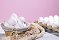 White Chicken eggs in a cardboard box and in a Straw basket on a pink background with piece of cloth, Raw Fresh Chicken Royalty Free Stock Photo
