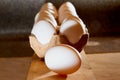 White chicken eggs in cardboard on wooden surface with interesting light. The concept of taking pictures of food. Fresh eggs from Royalty Free Stock Photo