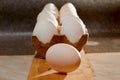 White chicken eggs in cardboard on wooden surface with interesting light. The concept of taking pictures of food. Fresh eggs from Royalty Free Stock Photo