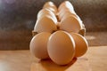 White chicken eggs in cardboard on wooden surface with interesting light. The concept of taking pictures of food. Fresh eggs from Royalty Free Stock Photo