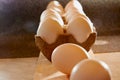 White chicken eggs in cardboard on wooden surface with interesting light. The concept of taking pictures of food. Fresh eggs from Royalty Free Stock Photo