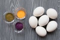 White chicken eggs and color dyes on a gray table. Celebrating E Royalty Free Stock Photo