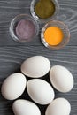 White chicken eggs and color dyes on a gray table. Celebrating E Royalty Free Stock Photo