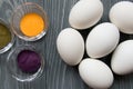 White chicken eggs and color dyes on a gray table. Celebrating E Royalty Free Stock Photo