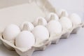 White chicken eggs in an eco-friendly paper container. Healthy diet food. Close-up. White background. Space for text Royalty Free Stock Photo