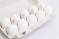 White chicken eggs in an eco-friendly paper container. Healthy diet food. Close-up. White background. Space for text Royalty Free Stock Photo