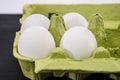 White, chicken eggs in a green tray. Close-up. Royalty Free Stock Photo