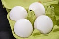 White, chicken eggs in a green tray. Close-up. Royalty Free Stock Photo