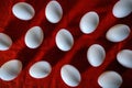 White chicken eggs on red surface Royalty Free Stock Photo