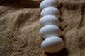 White chicken eggs. White eggs lie on sacking Royalty Free Stock Photo