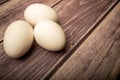 White chicken eggs on a wooden background. Close up Royalty Free Stock Photo